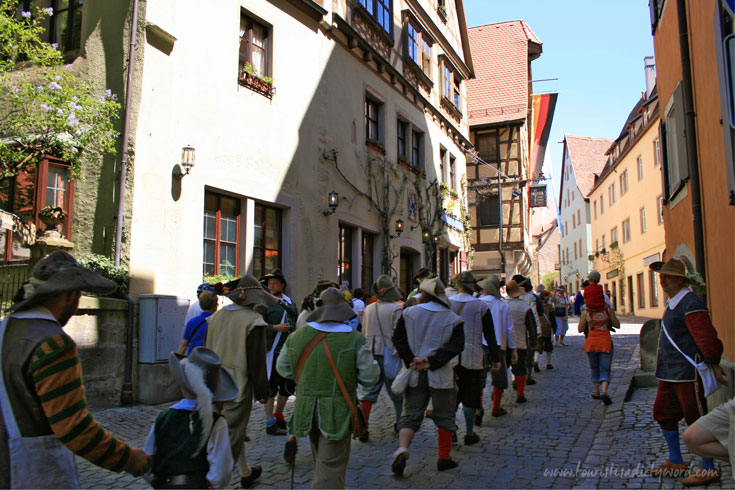 Historically costumed re-enactors march down the streets of Rothenburg during the Master Draught Festival