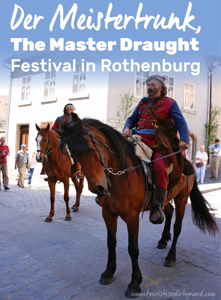 Historically costumed riders parade through the streets of Rothenburg during The Master Draught festival 