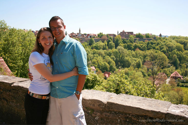 Denise and Sebastian, bloggers of Tourist is a Dirty Word, a Germany Travel Blog, on the town wall of Rothenburg ob der Tauber
